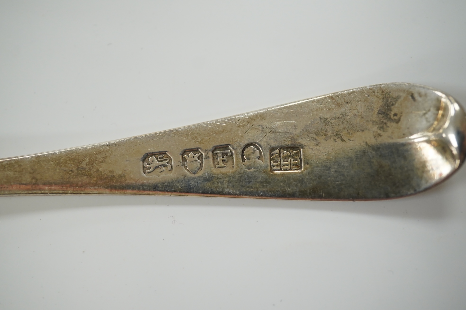 Small silver including a pair of napkin rings and two others, a Georgian sauce ladle and two similar dessert spoons, a fish slice, fork and an unmarked toddy ladle with inset coin bowl. Condition - poor to fair